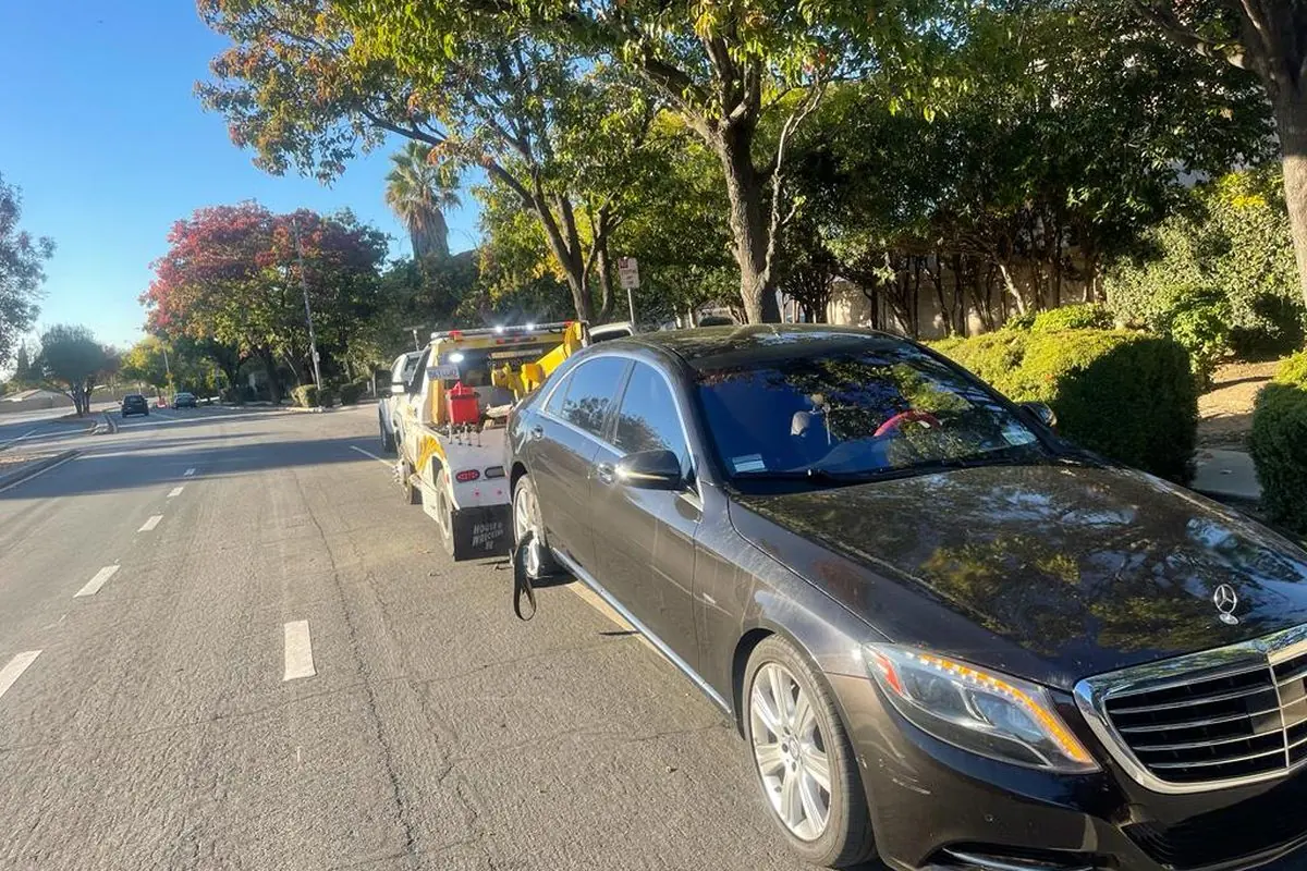 Mercedes S-Class being winched onto a Guerra Towing flatbed on a San Jose street