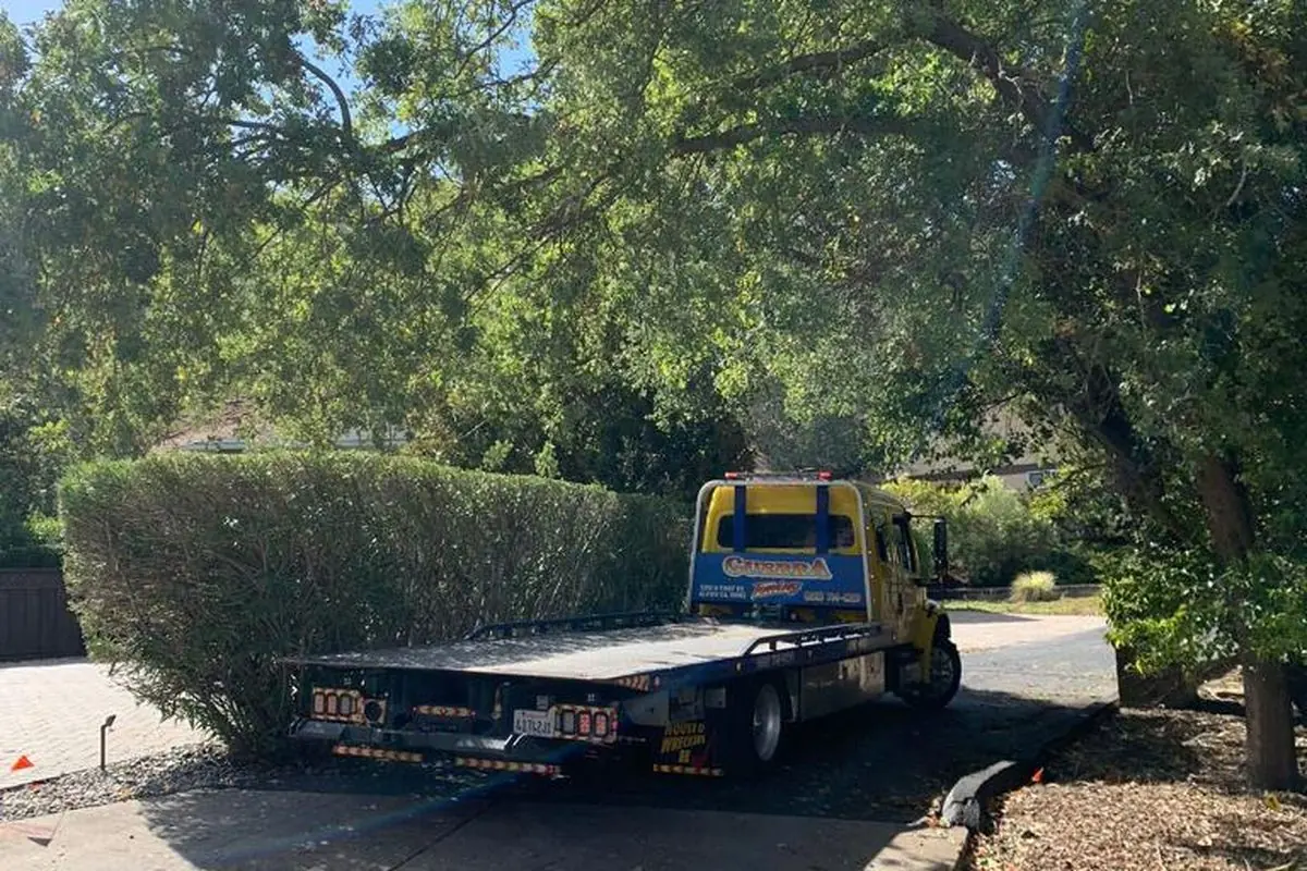 Guerra Towing deck lowered at the curb outside a San Jose home