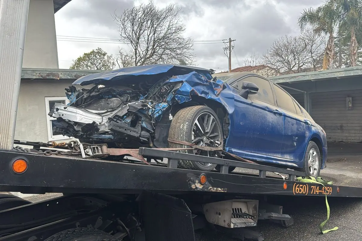 Wrecked Toyota Camry loaded on a Guerra Towing flatbed after a crash in San Jose